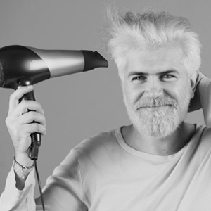man blow drying hair